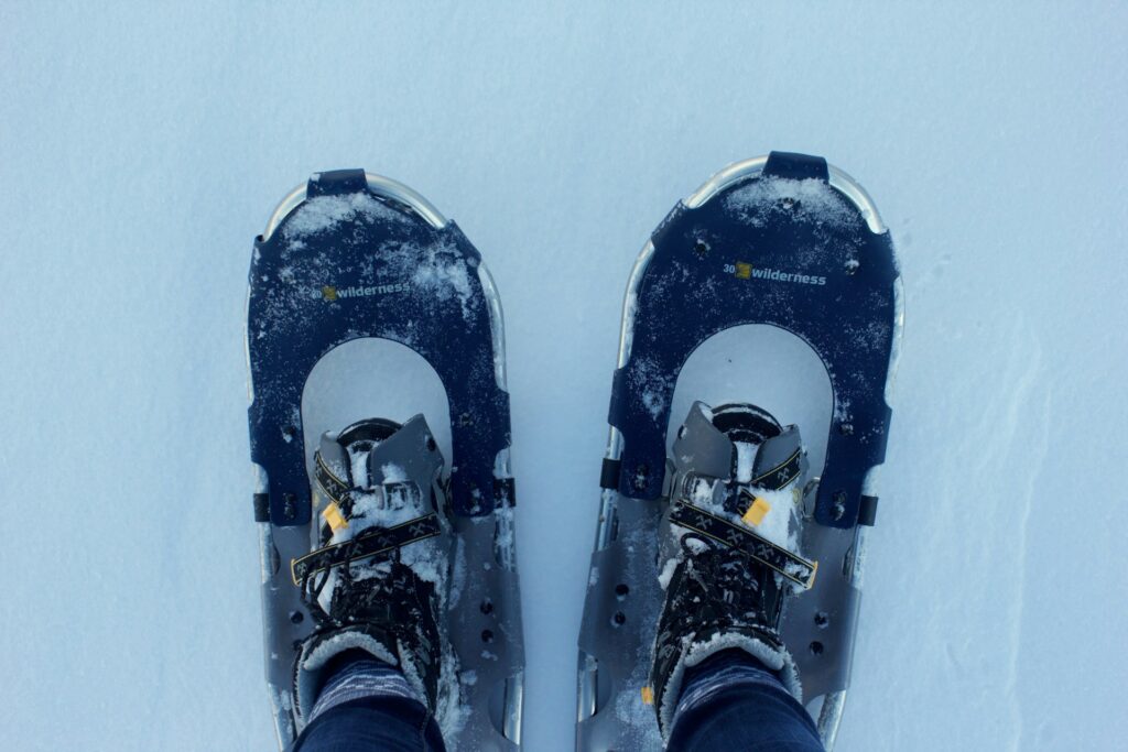 A view of snowshoes A person wearing snowshoes