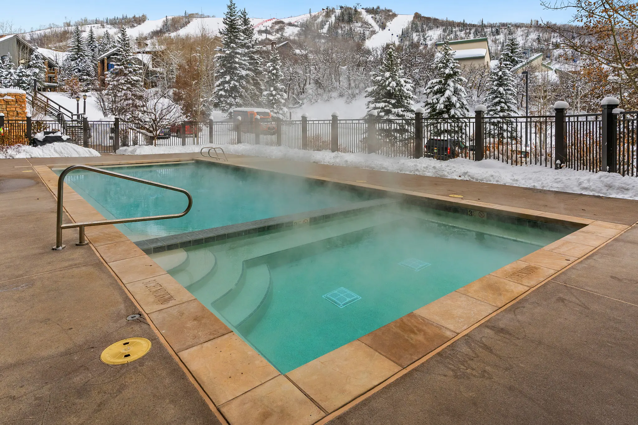Heated pool outside a rental home on a snowy day
